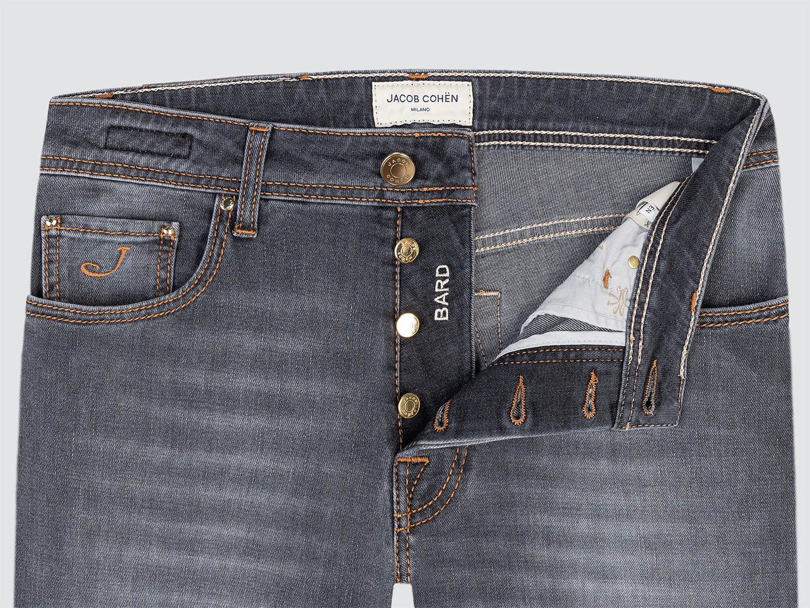 Close-up of gray jeans Bard with visible branding on a light gray background