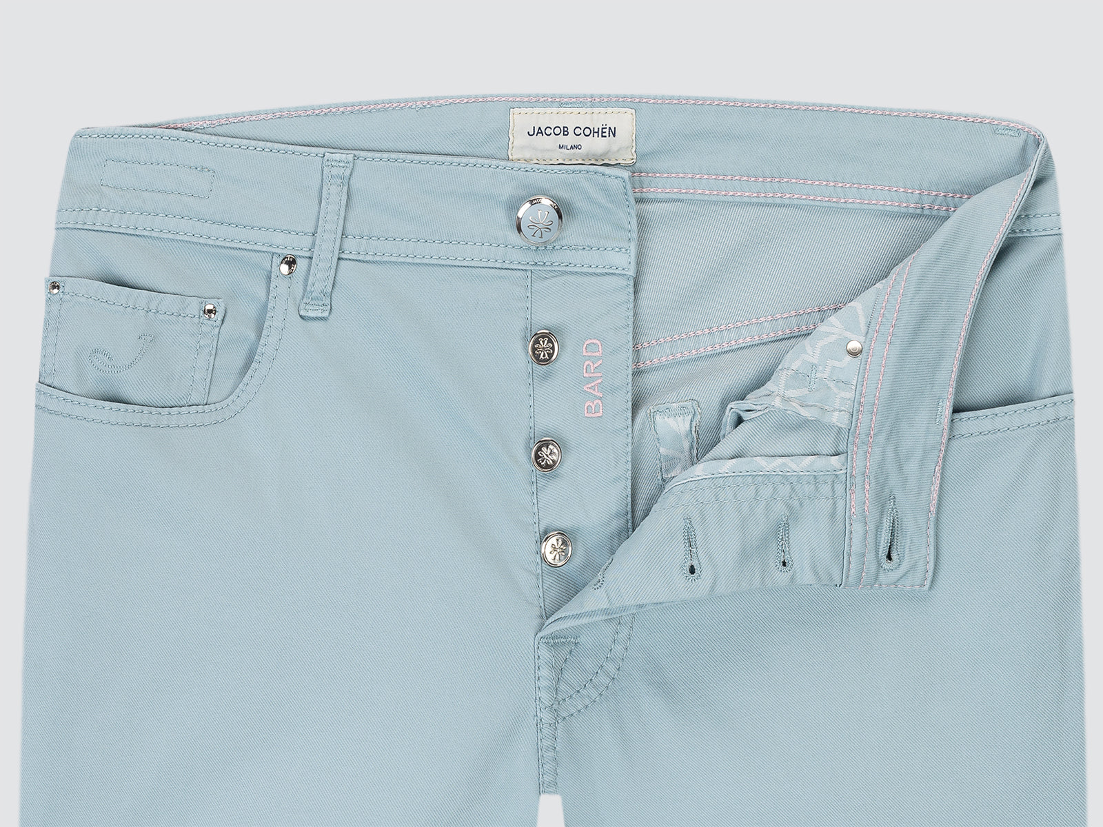 Light blue jeans with visible branding on a light gray background