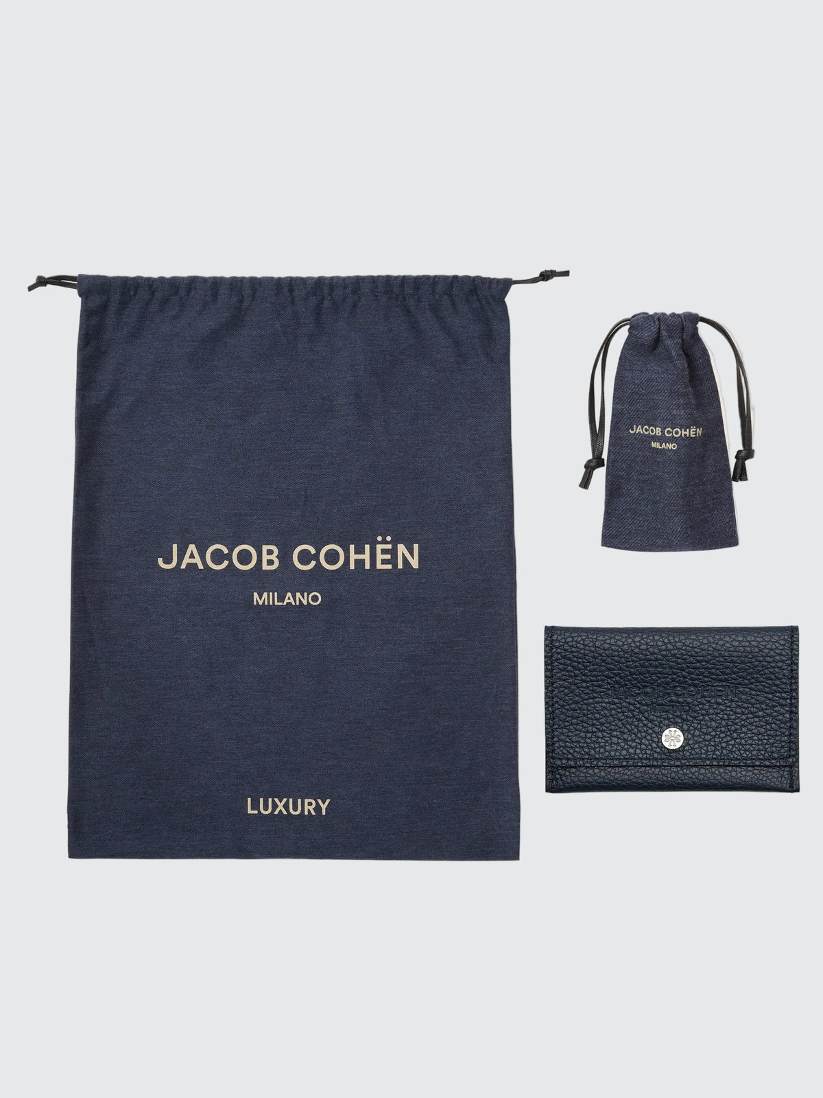Navy drawstring bag with 'Jacob Cohen' branding on a beige background