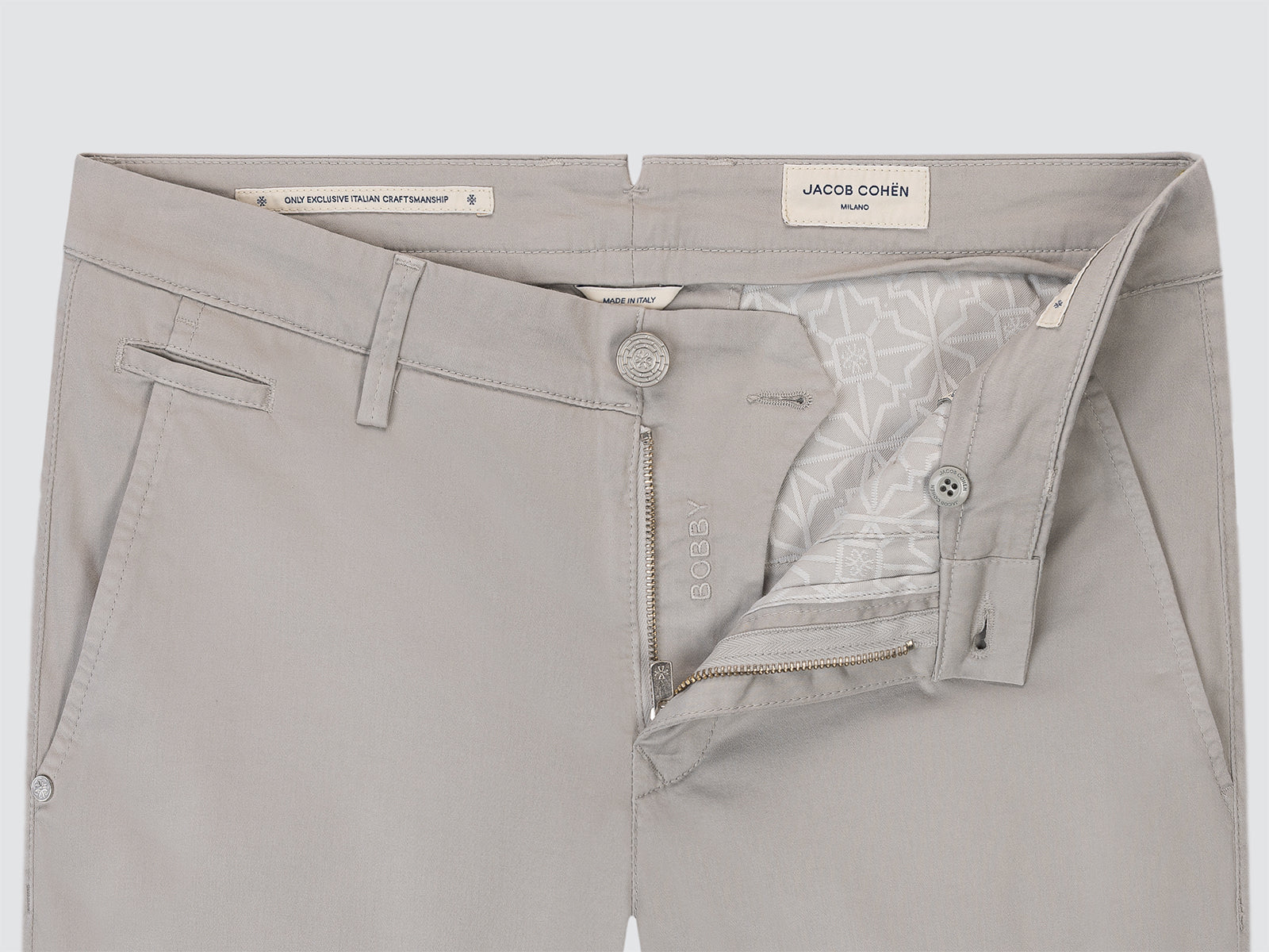Gray pants with a brand label on a light gray background