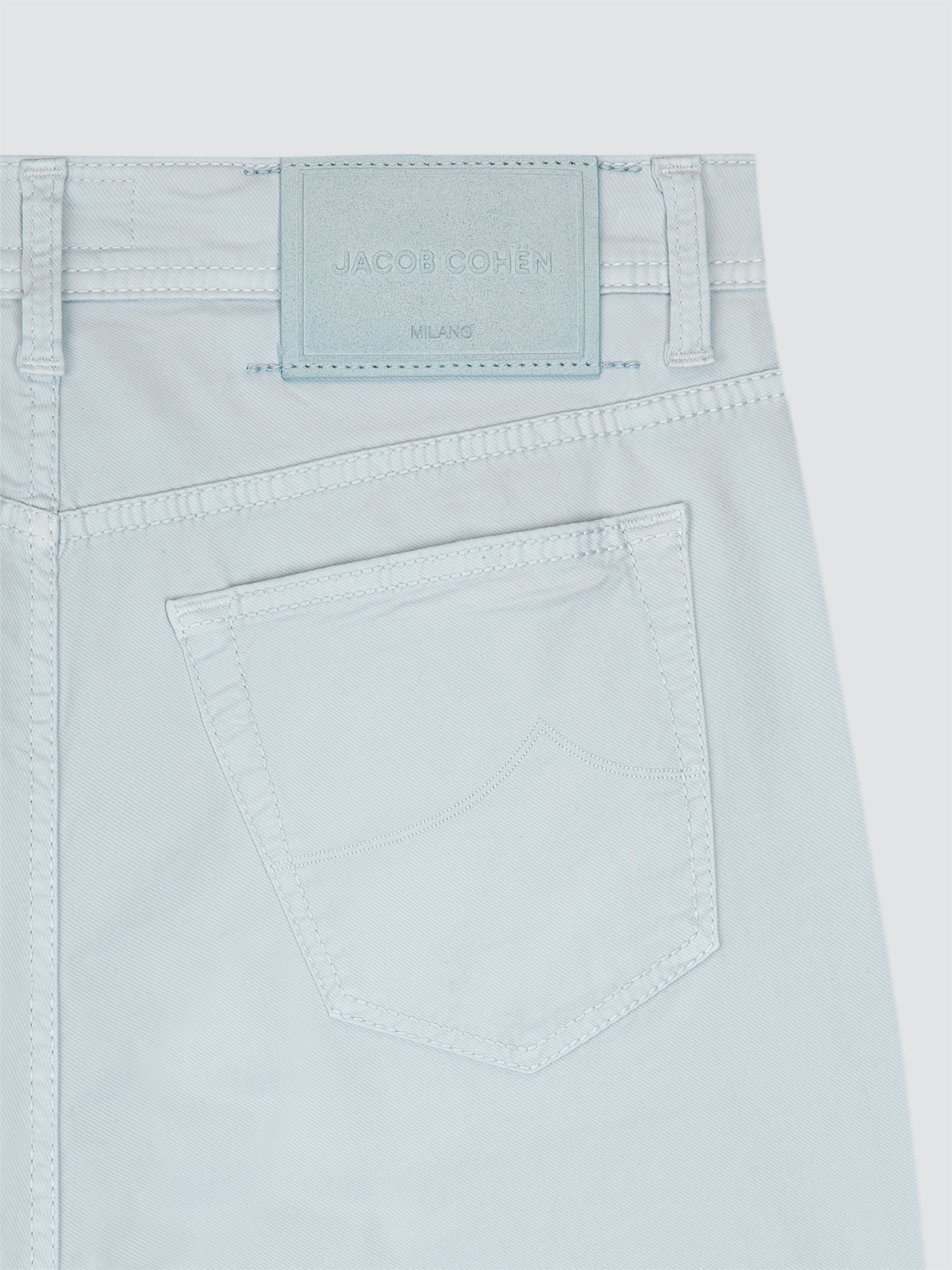 Light blue jeans Jacob Cohen with a brand label on a white background