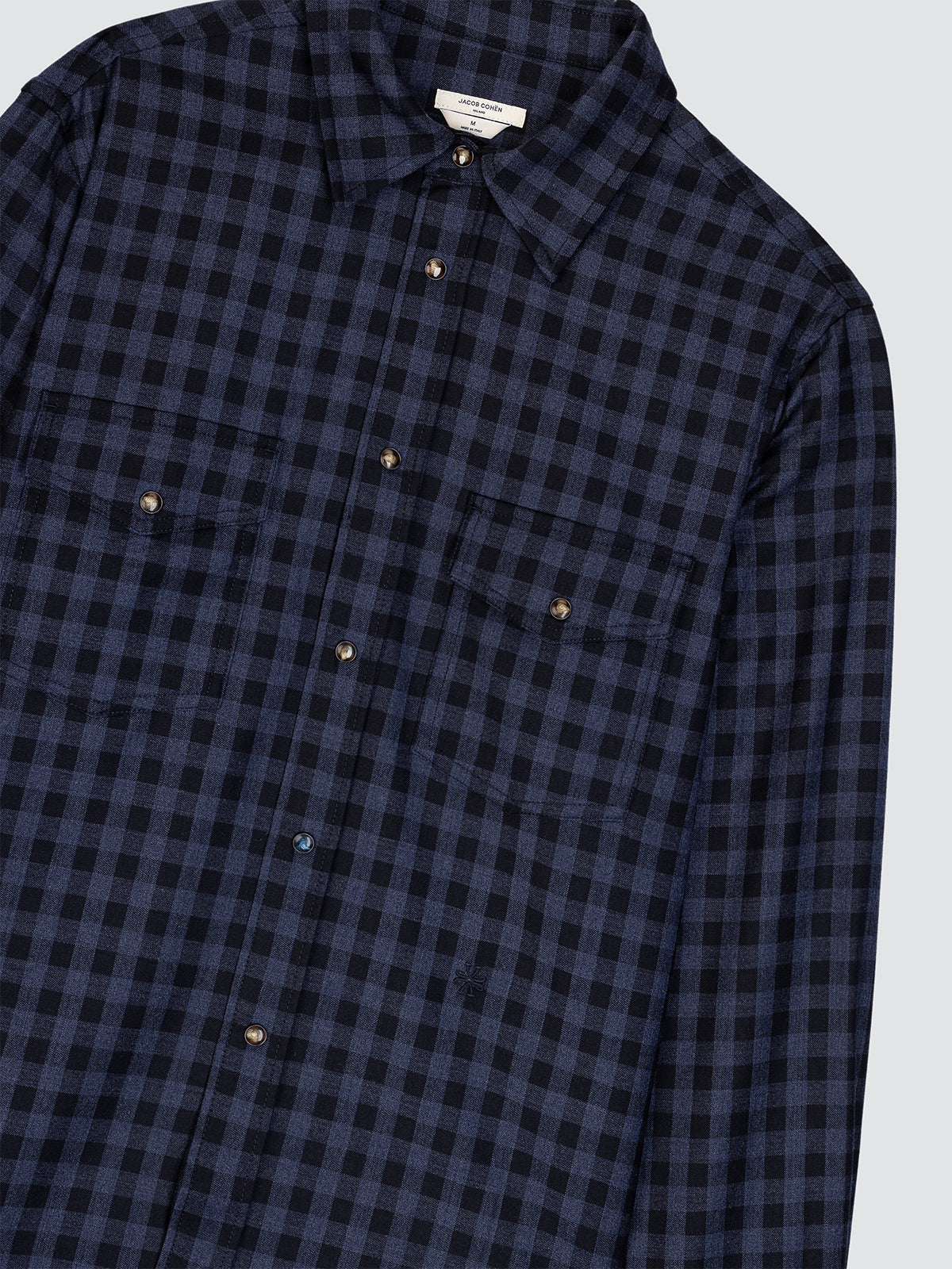 Blue and black checkered shirt on a light gray background