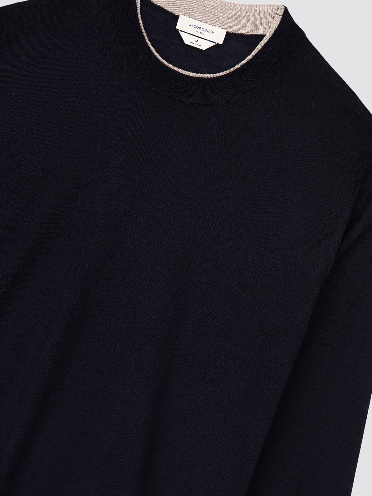 navy blue Jacob Cohen sweater with a close-up of the neckline on a light gray background
