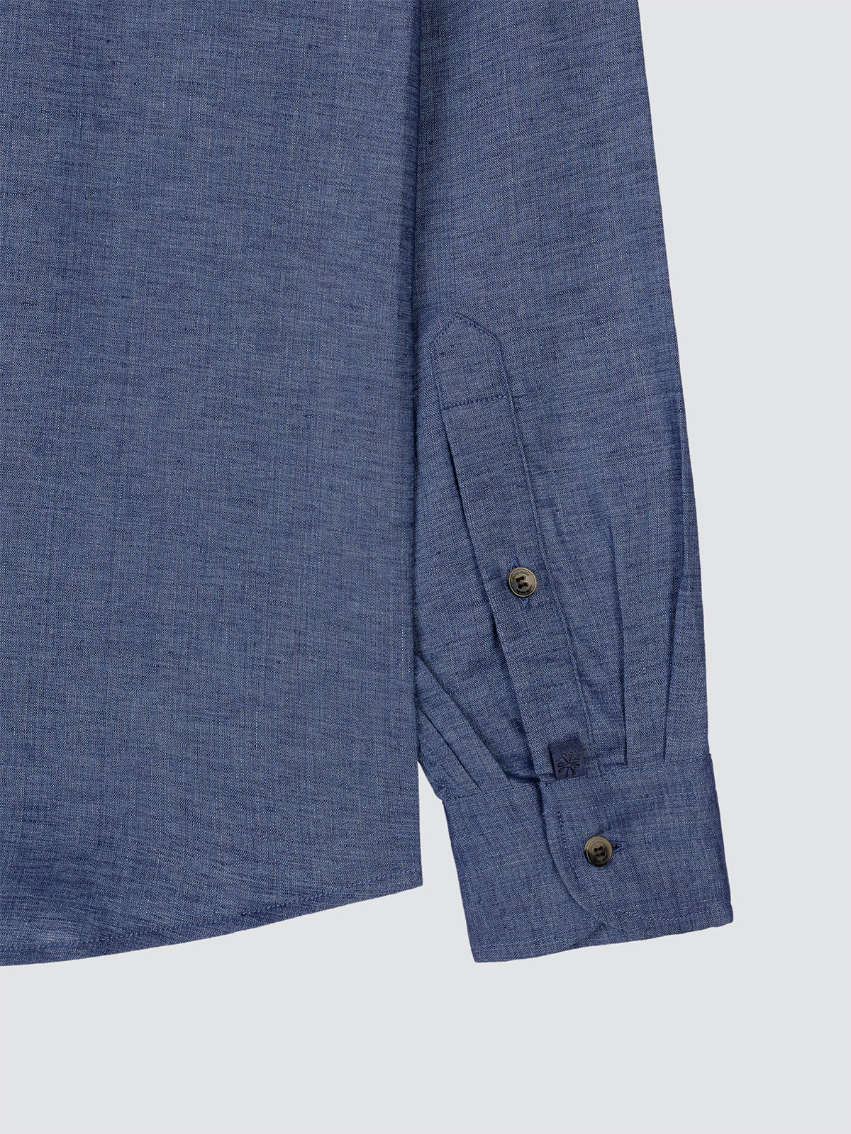 Close-up of a blue shirt with buttons on a white background