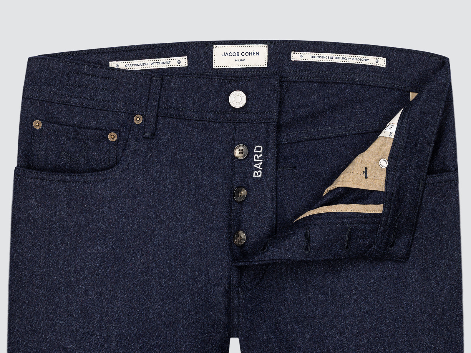 Dark blue jeans with visible branding on a light gray background