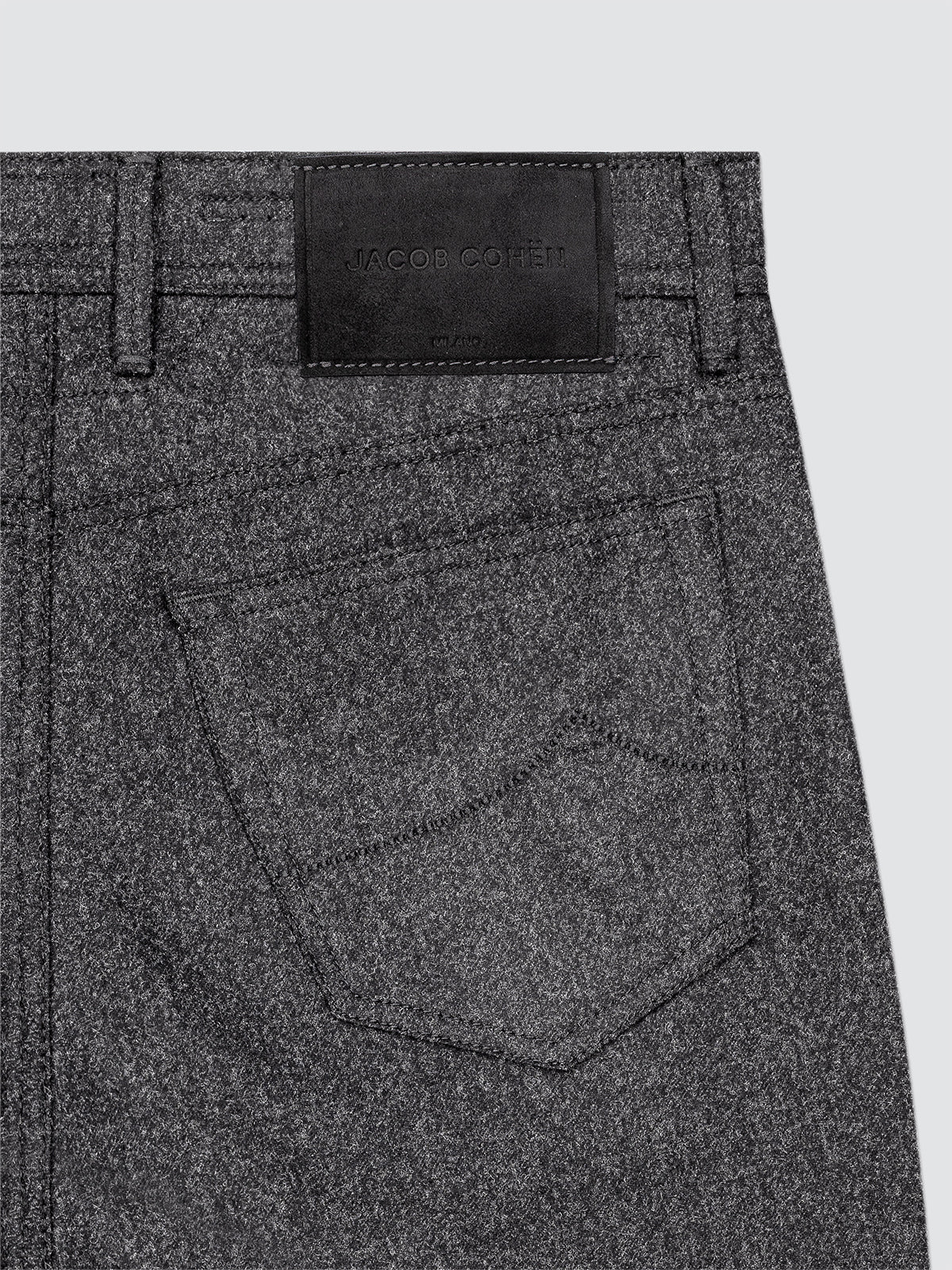 Gray pants with a brand label on a light gray background