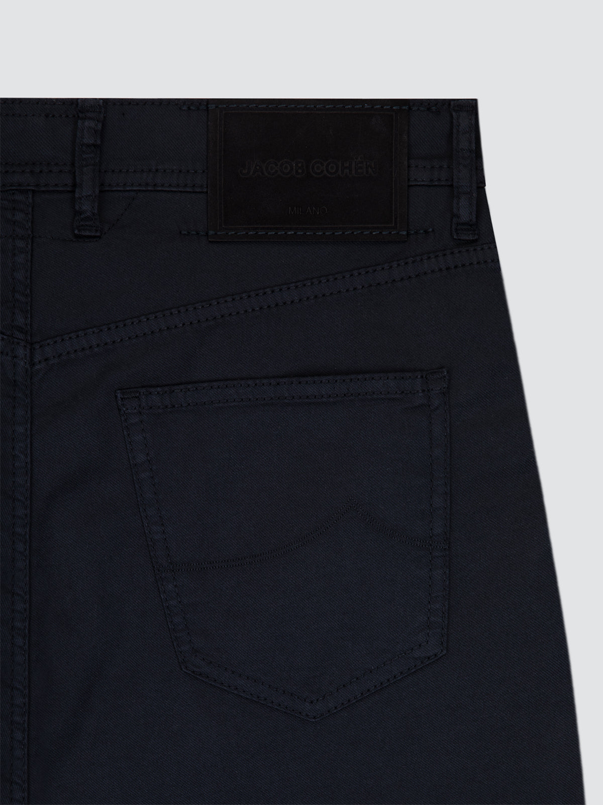 Close-up of Navy blue shorts Jacob Cohën with a visible brand label on a light gray background