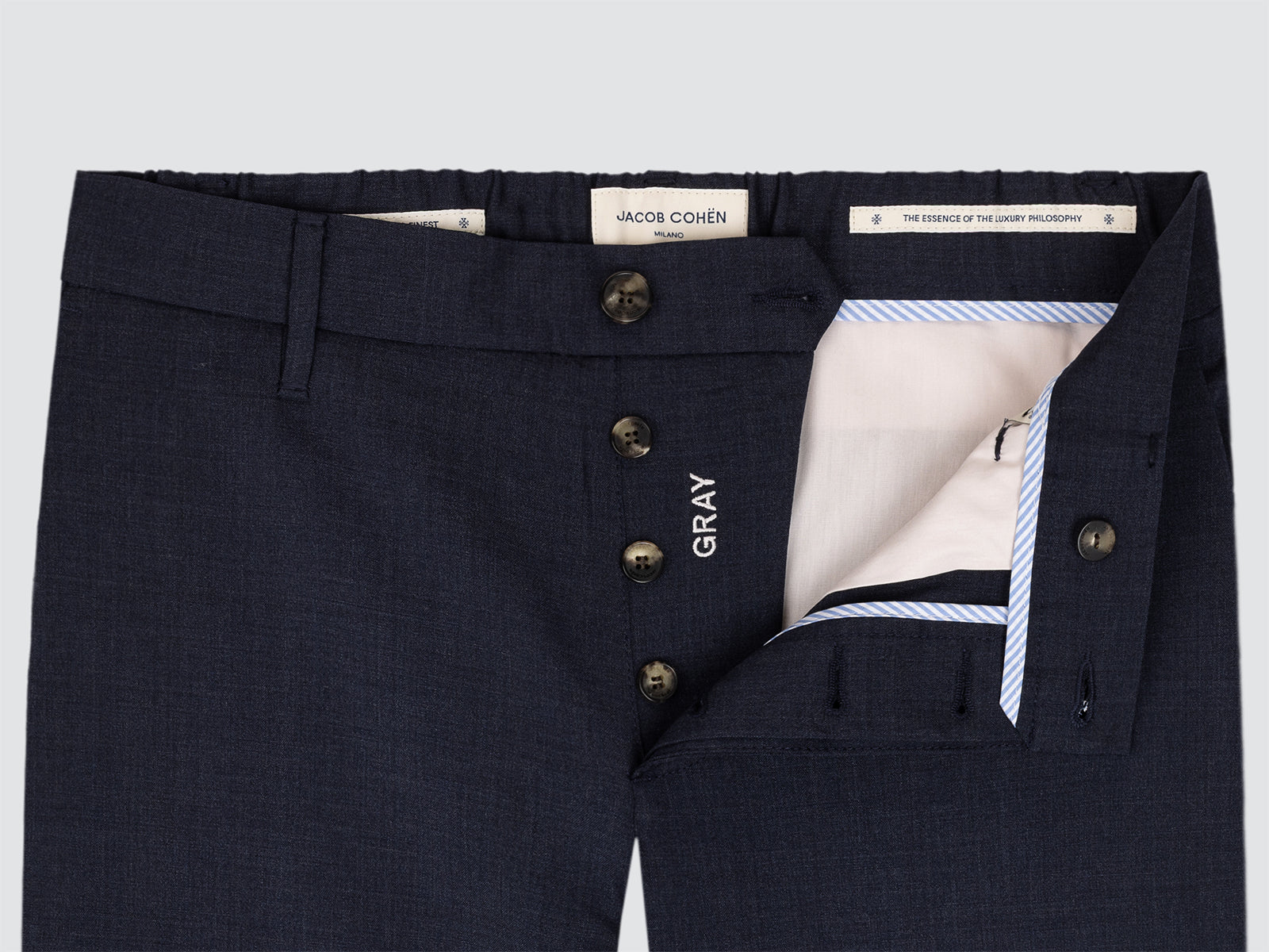 Navy blue pants with gold buttons and 'Gray' label on a light gray background