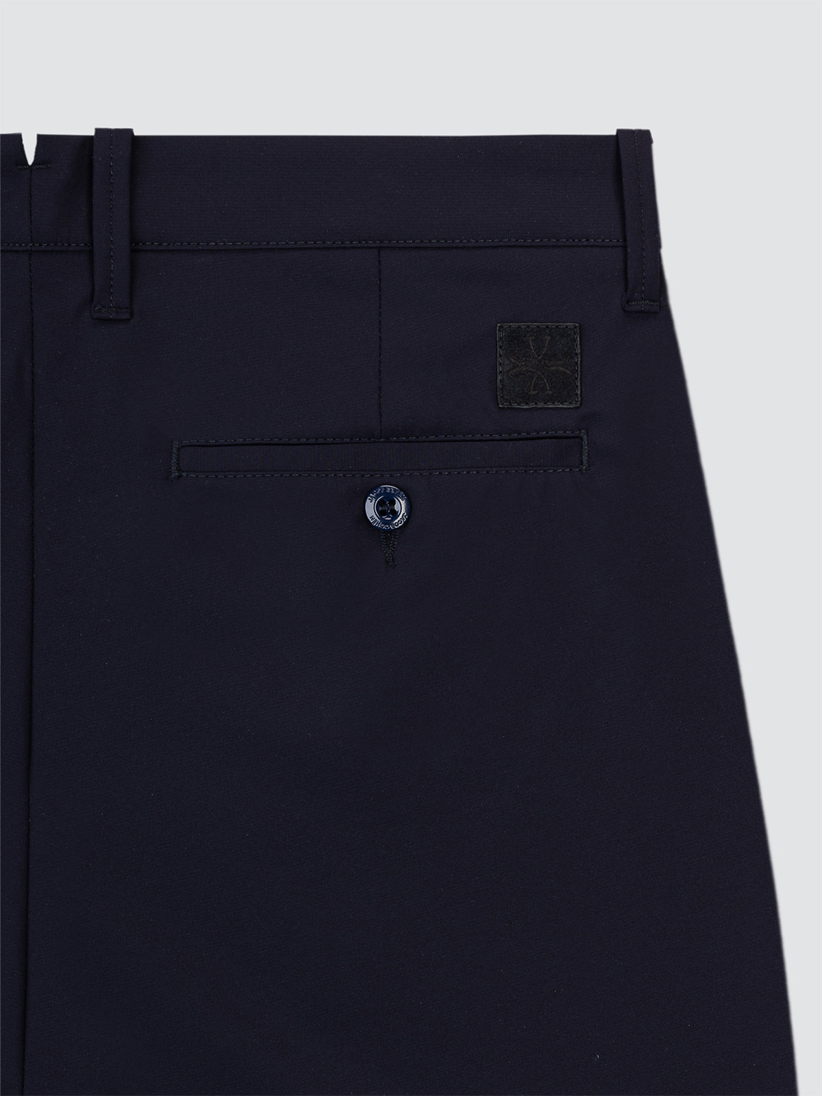 Close-up of dark blue Bermuda Jacob Cohen with a button and pocket detail on a light gray background