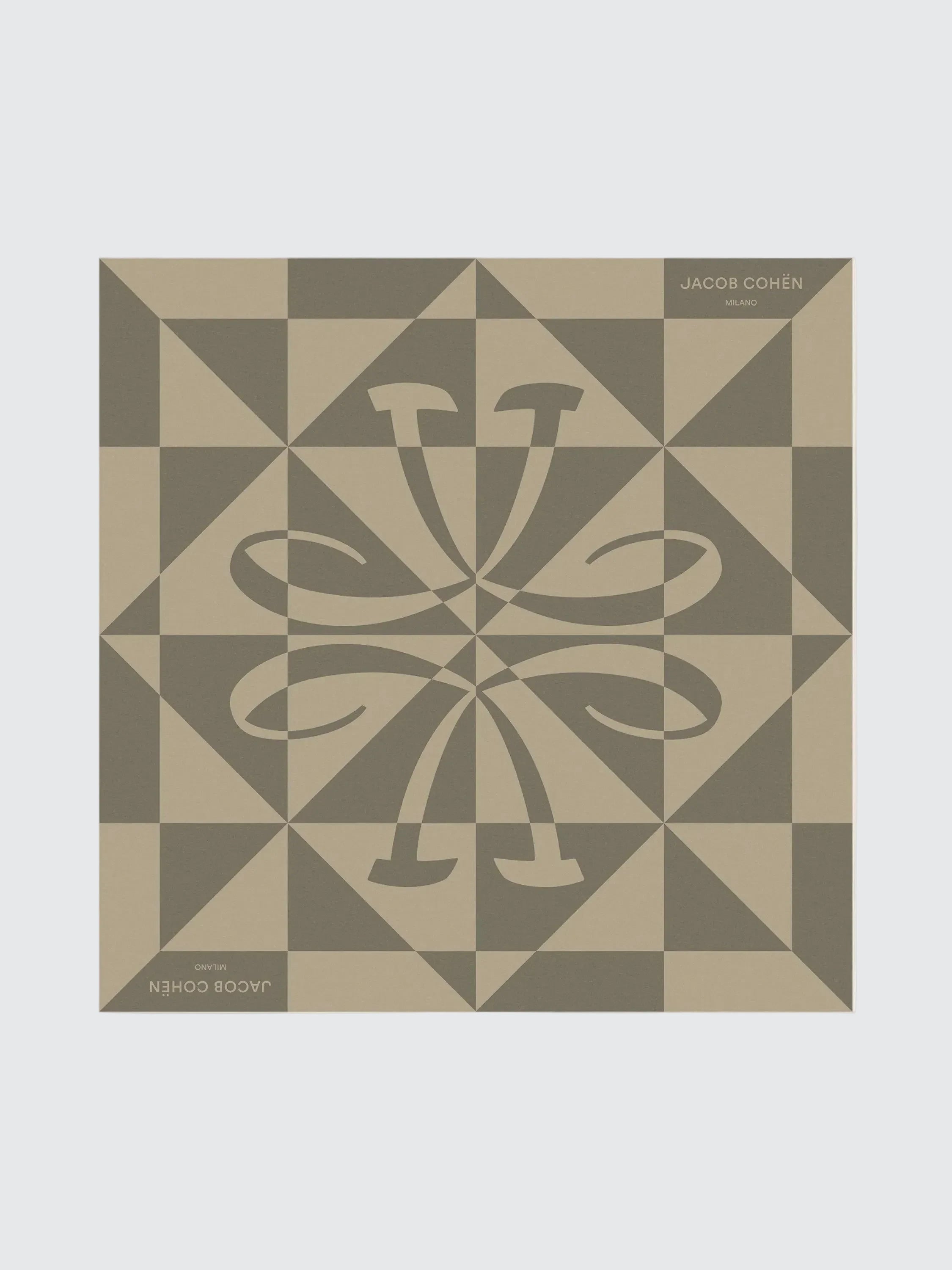 Decorative tile with geometric pattern and central design on a beige background
