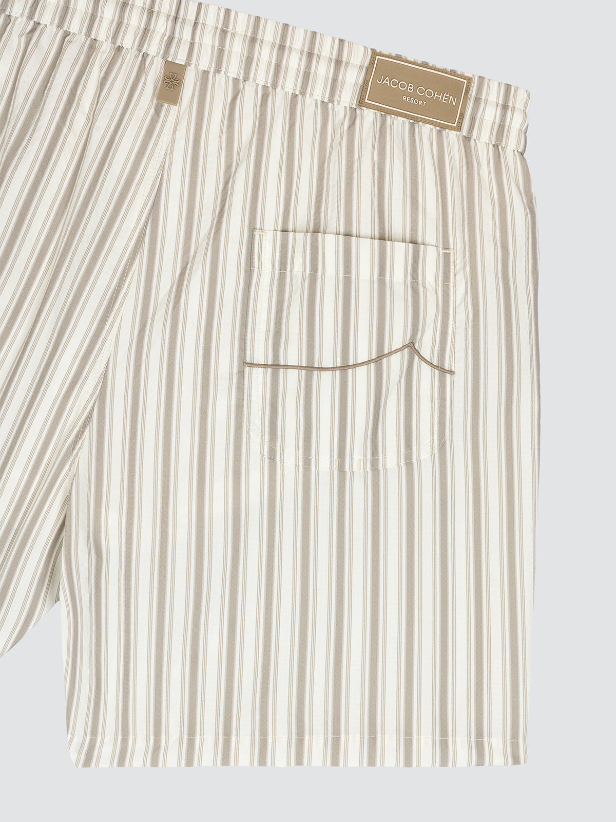 Striped beige and white swim trunks by Jacob Cohën. Lightweight, quick-drying fabric with refined design. Ideal for beach and resort wear. Resort Capsule