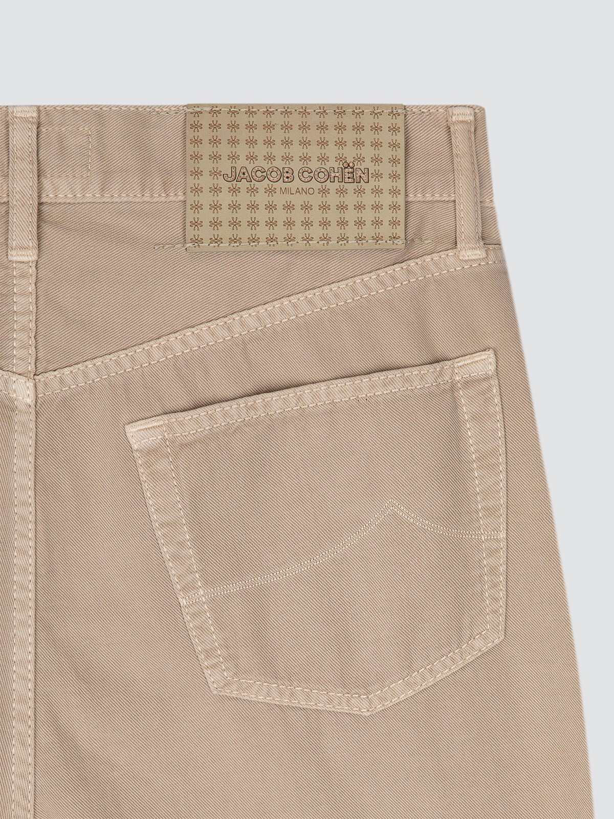 Beige pants Edo with a brand label Jacob Cohën on a white background