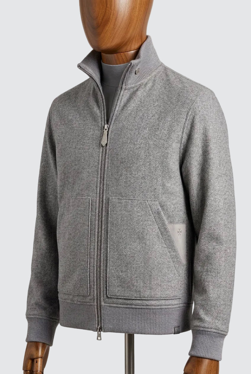 Grey herringbone wool zip jacket with knitted collar on a mannequin, three-quarter view
