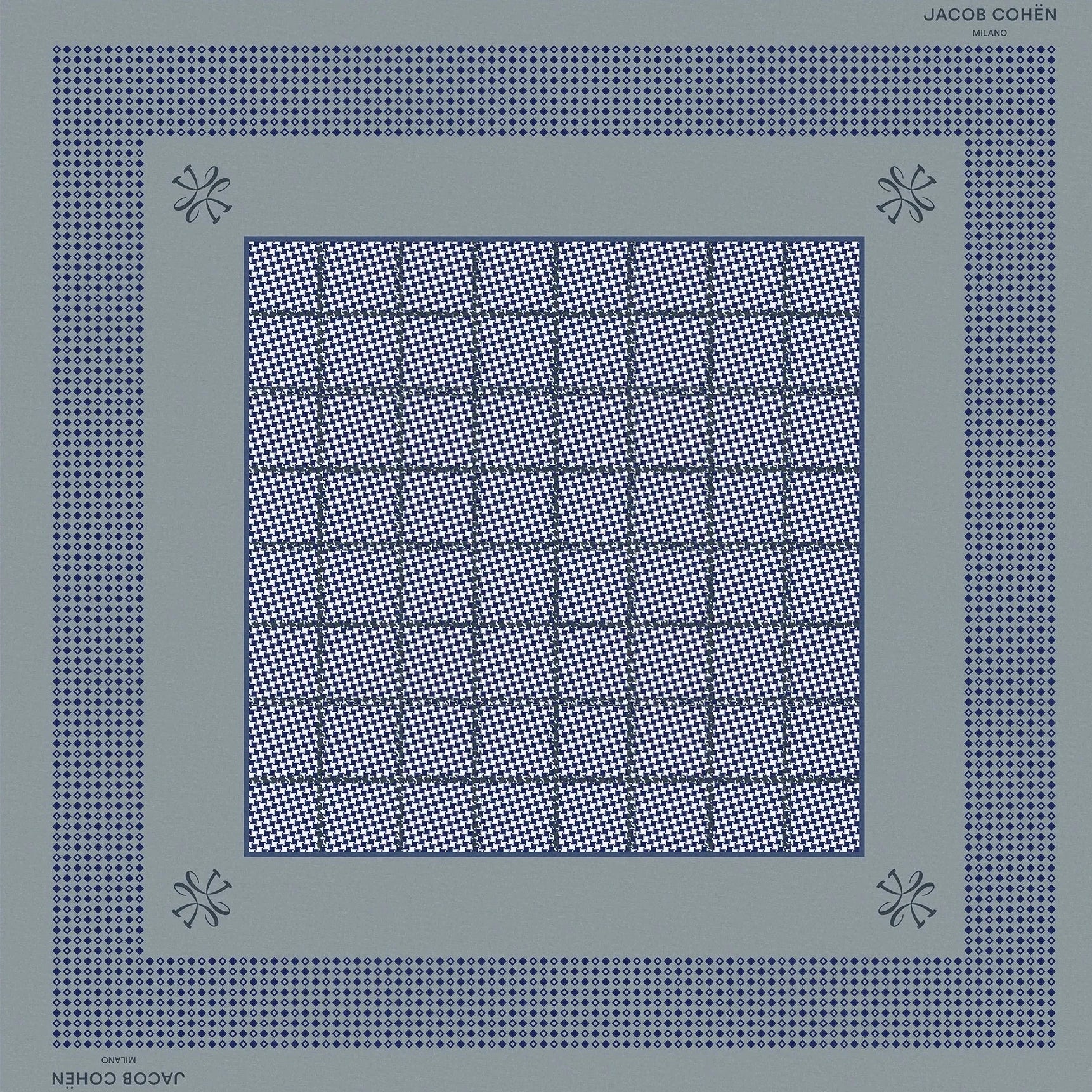 A square scarf by Jacques Coupin, featuring a geometric pattern in slate blue and navy blue on a light beige background.