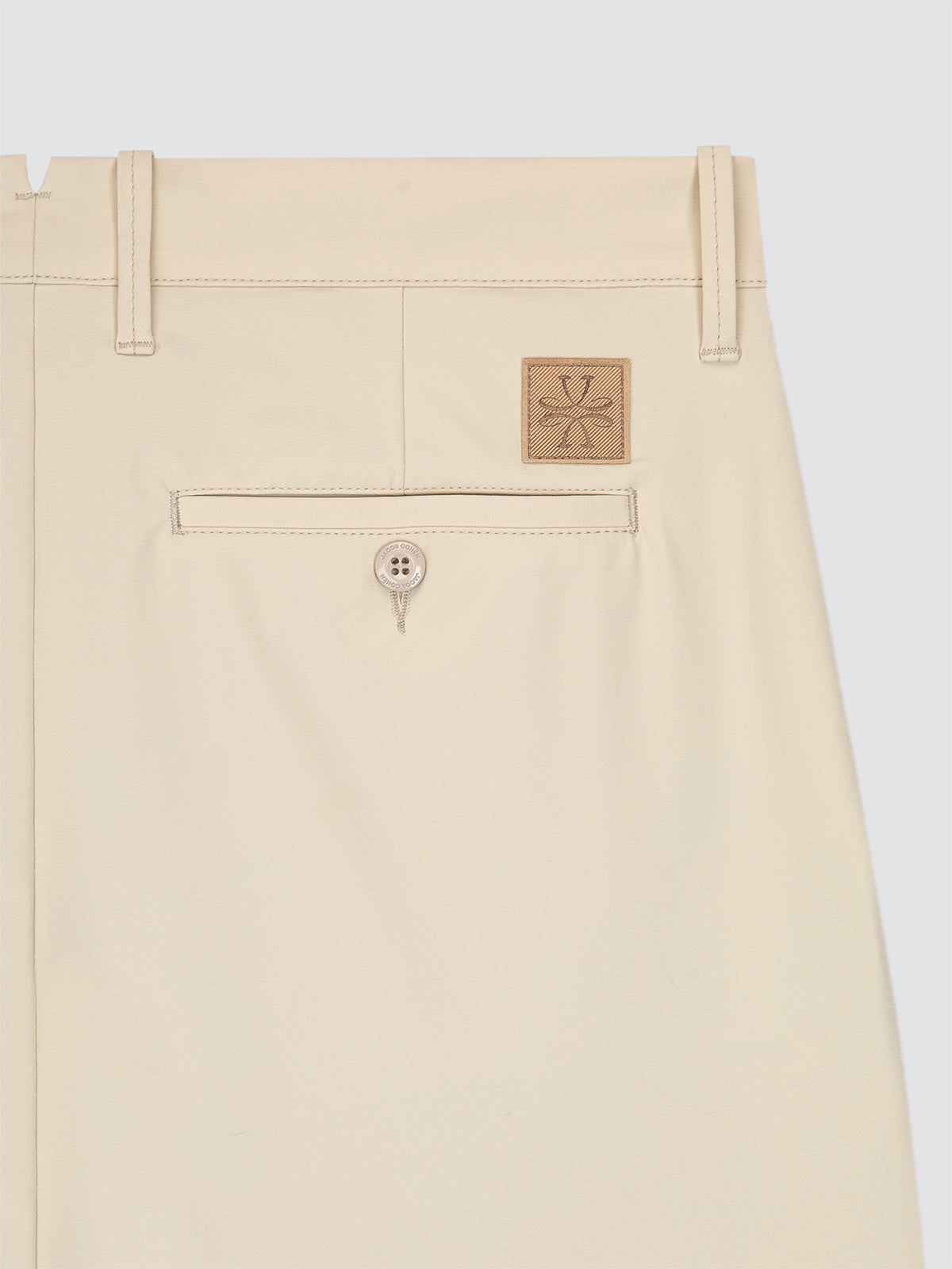 Beige short with a brand logo on a light gray background
