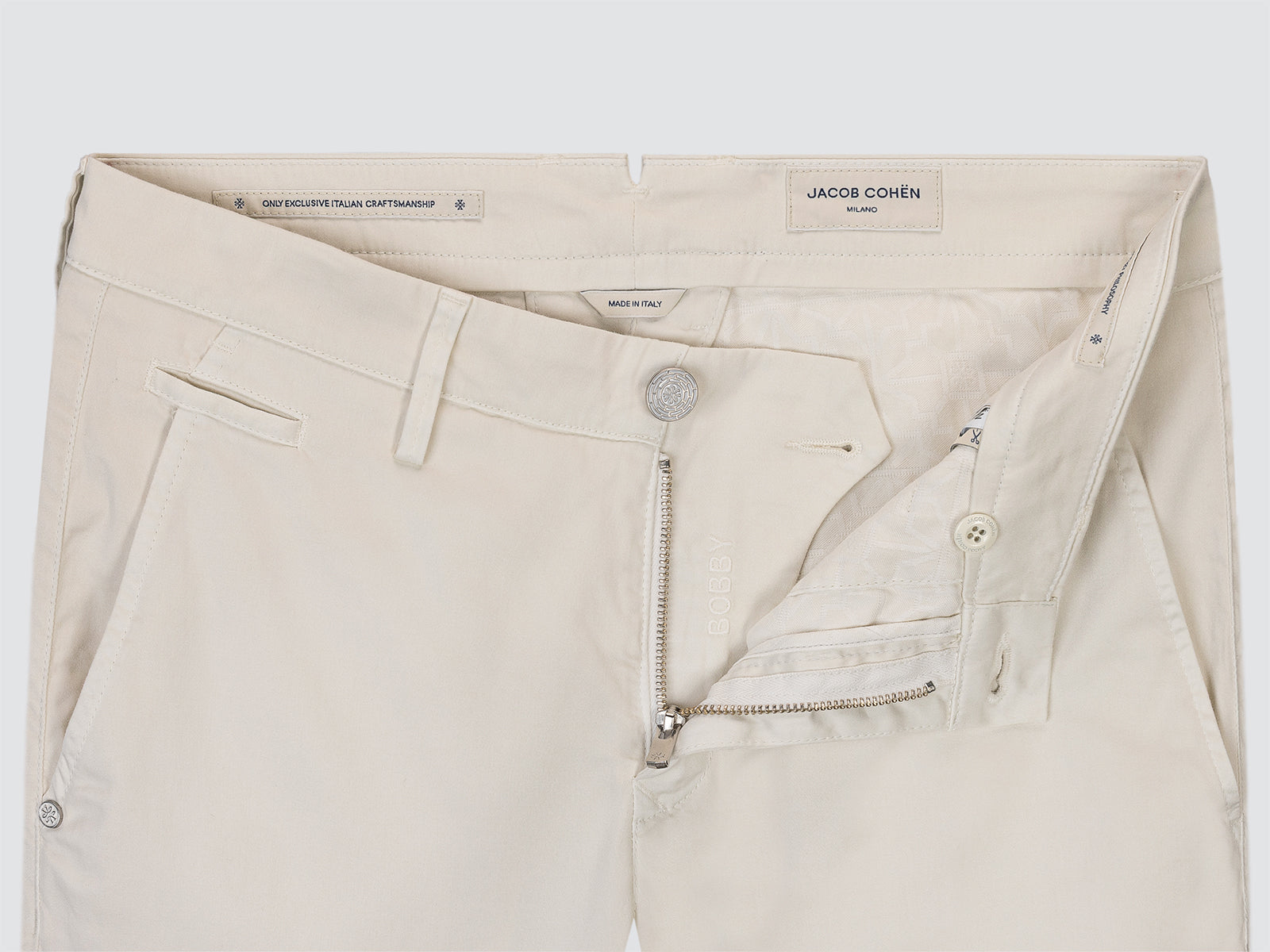 Beige pants with 'Jacob Cohen' branding on a white background