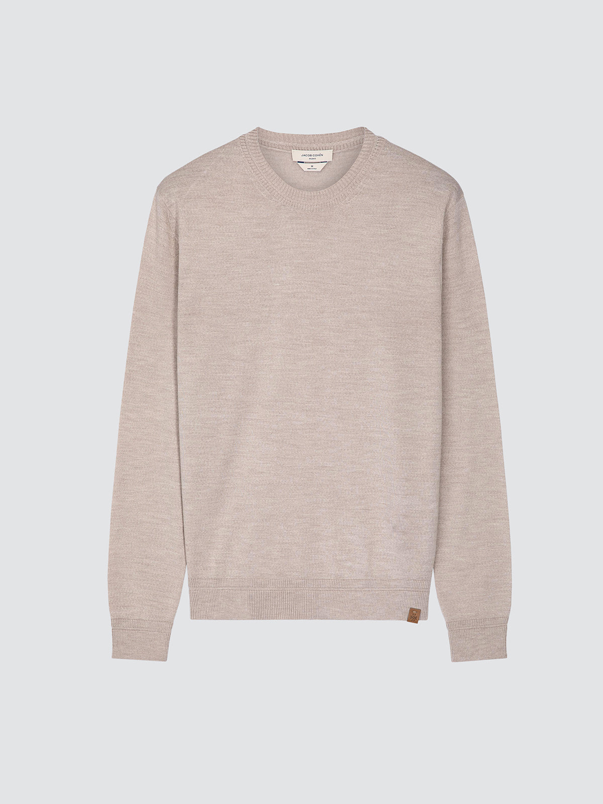 A light beige crewneck sweater with long sleeves, shown flat against a solid light gray background.