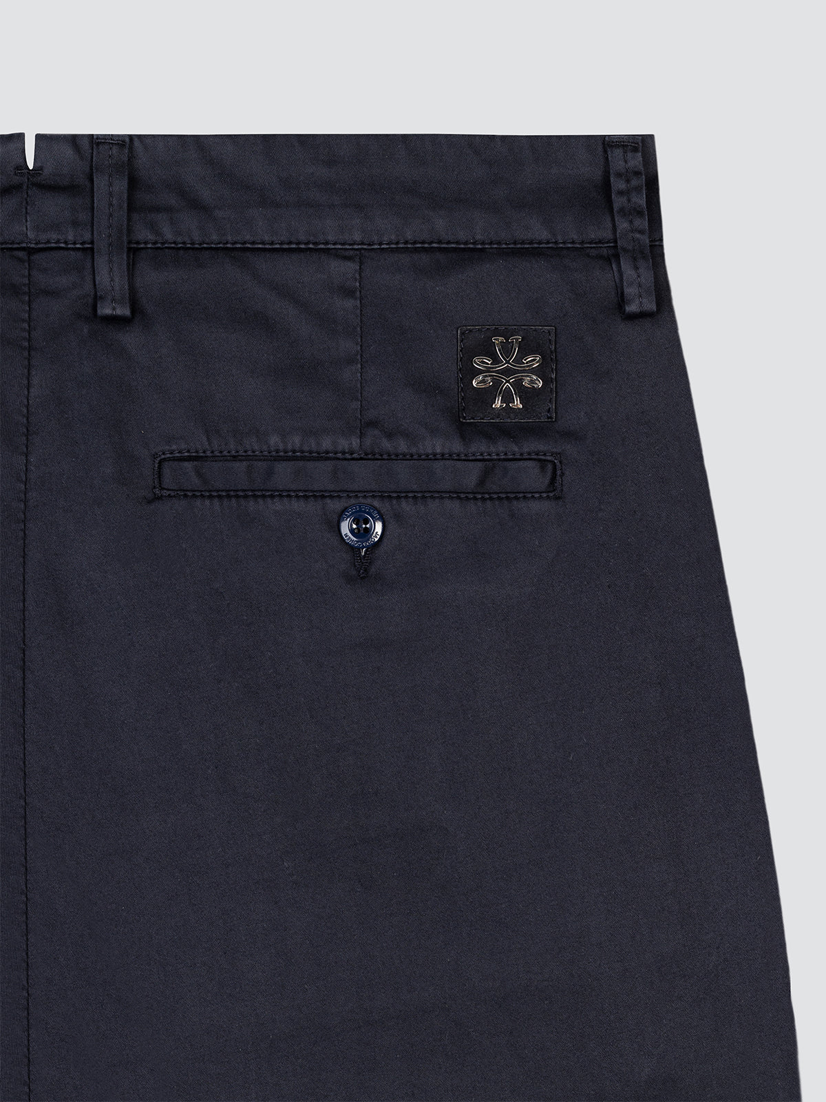 Navy blue Jacob Cohen pants with a brand logo on the pocket against a light gray background