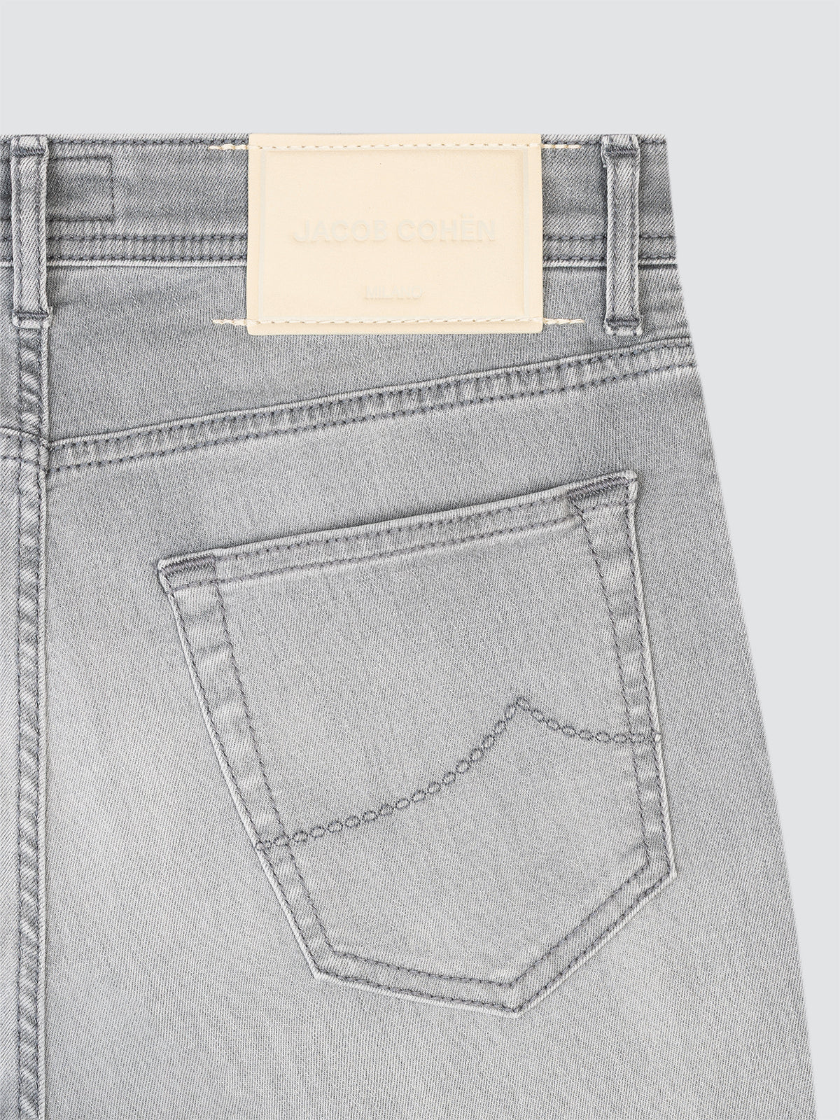 Gray jeans Jacob Cohen with a back pocket and brand label on a light gray background