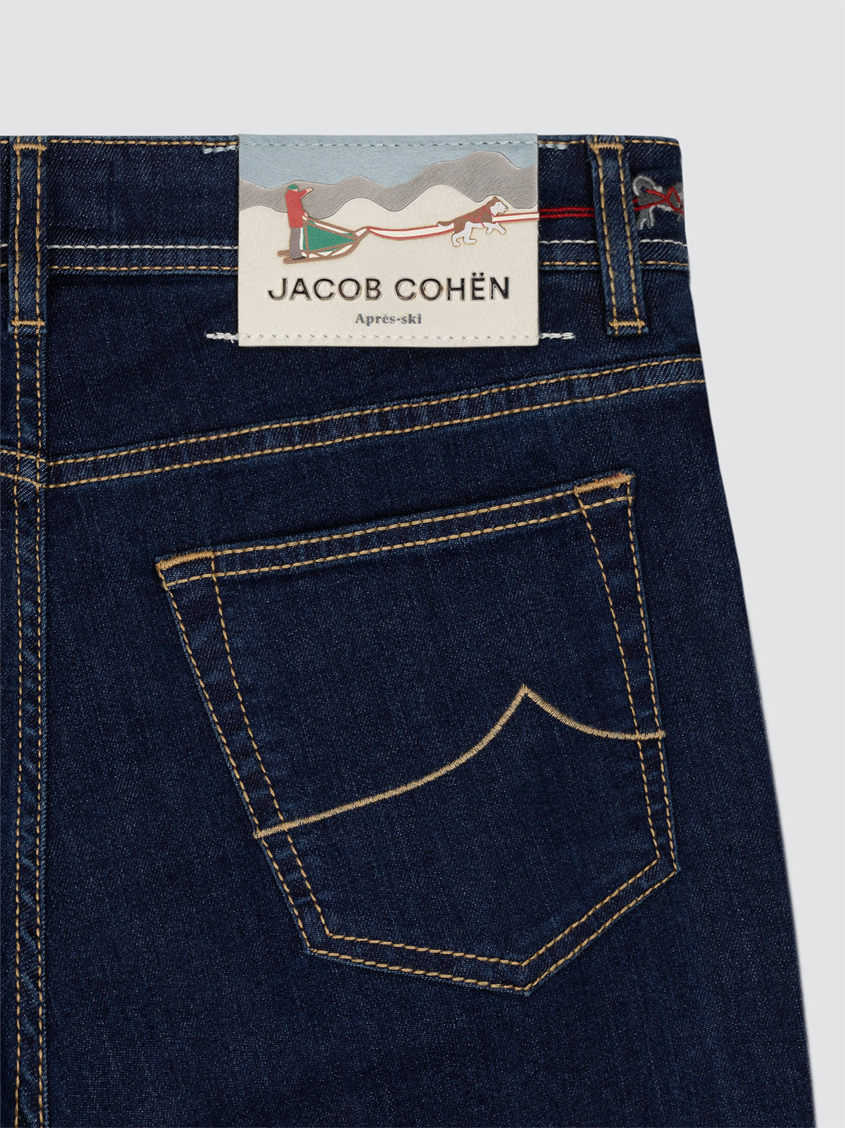 Dark blue jeans with a Jacob Cohen label on a white background APRES SKI