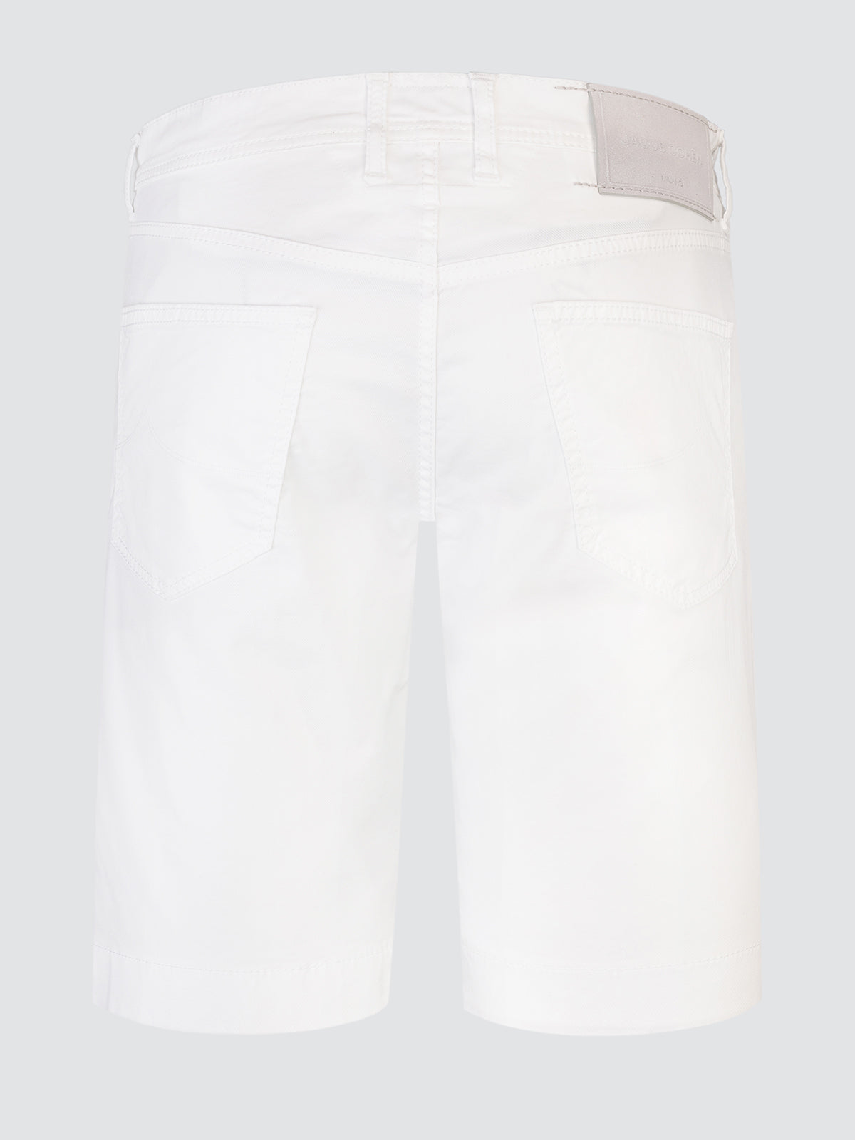 White shorts with a beige patch on a light gray background