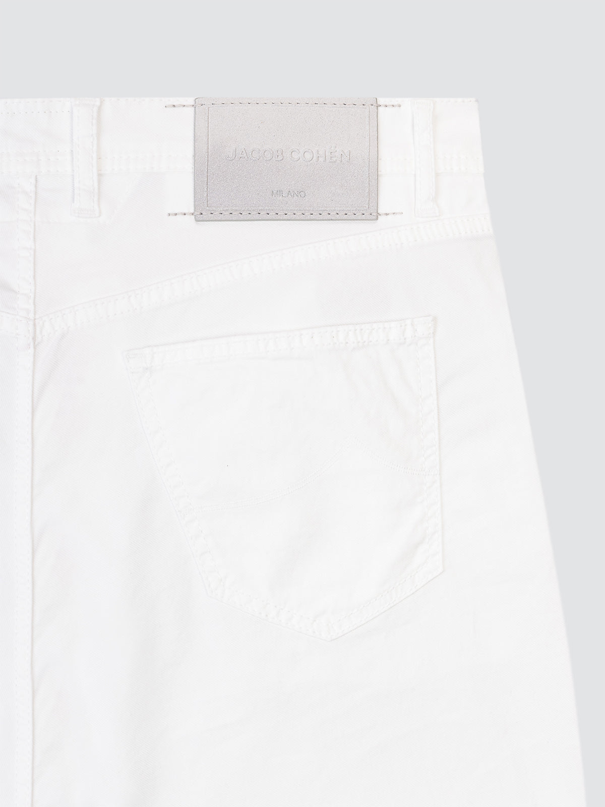 White Short with a brand label Jacob Cohen model Nicolas on a light gray background