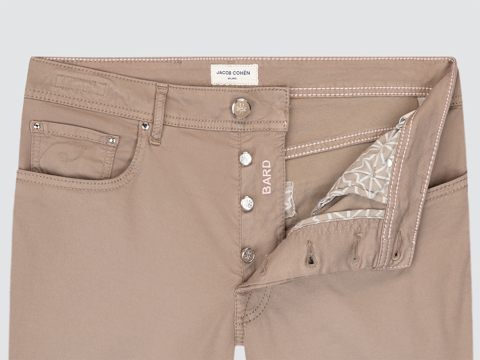 Brown pants with button details on a light gray background