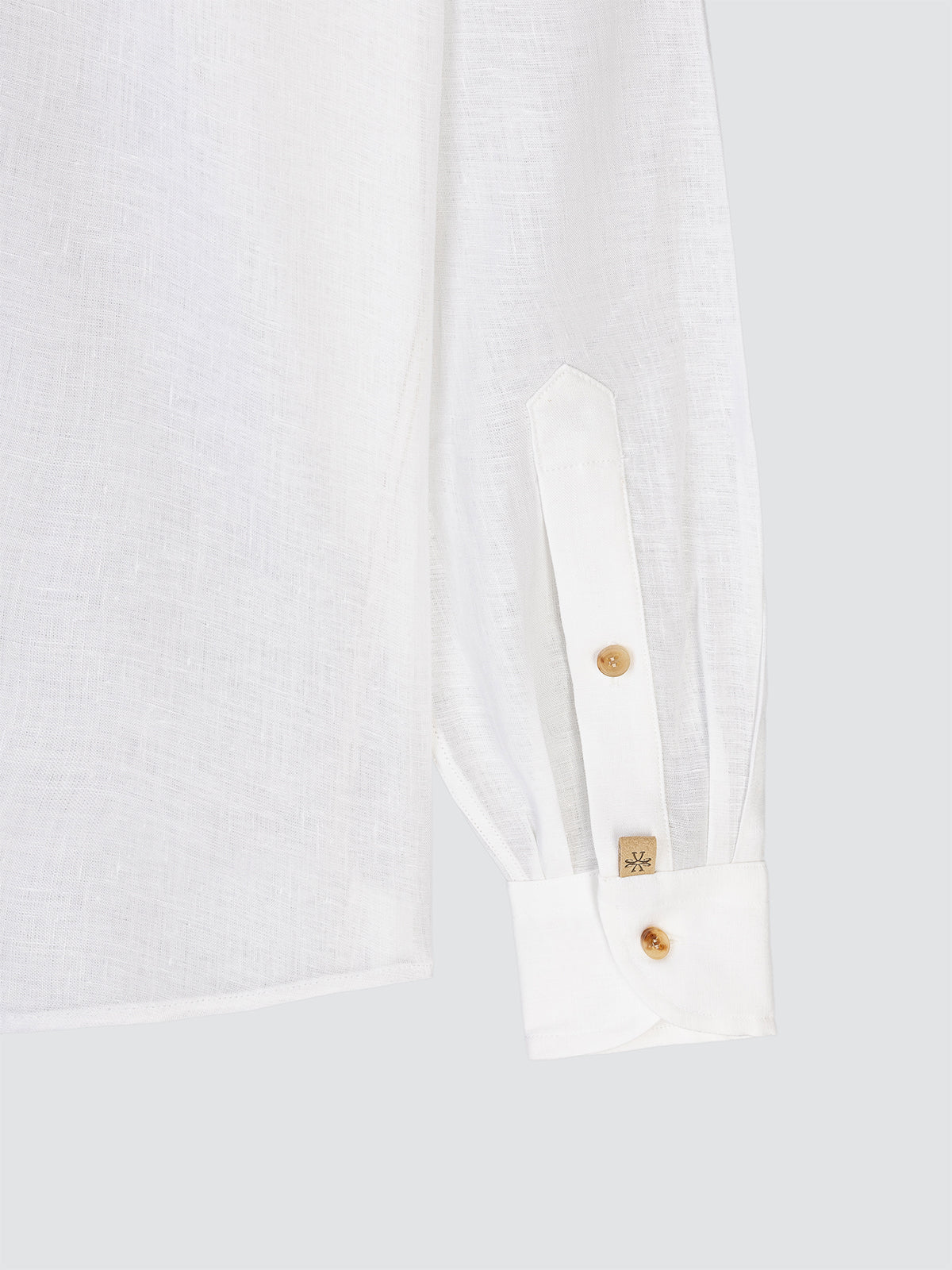 Close-up of a white shirt with horn buttons on a white background