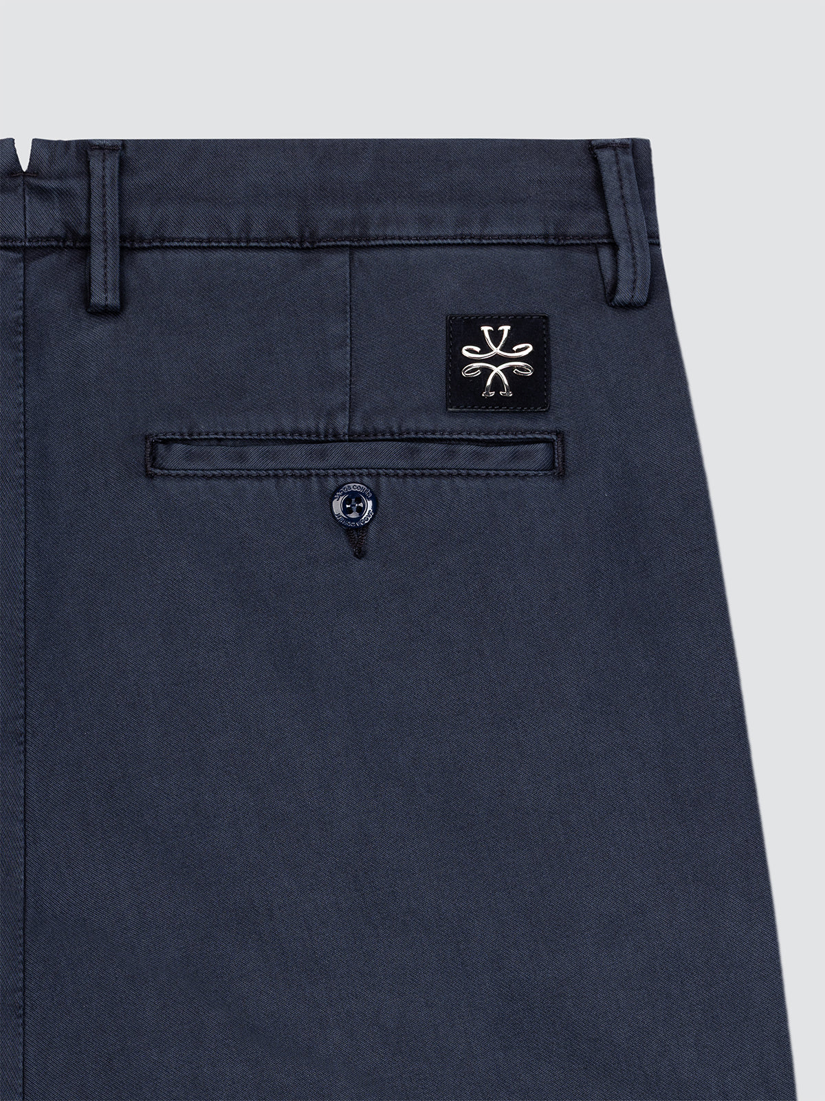 Navy pants with a brand logo Jacob Cohen on a light gray background