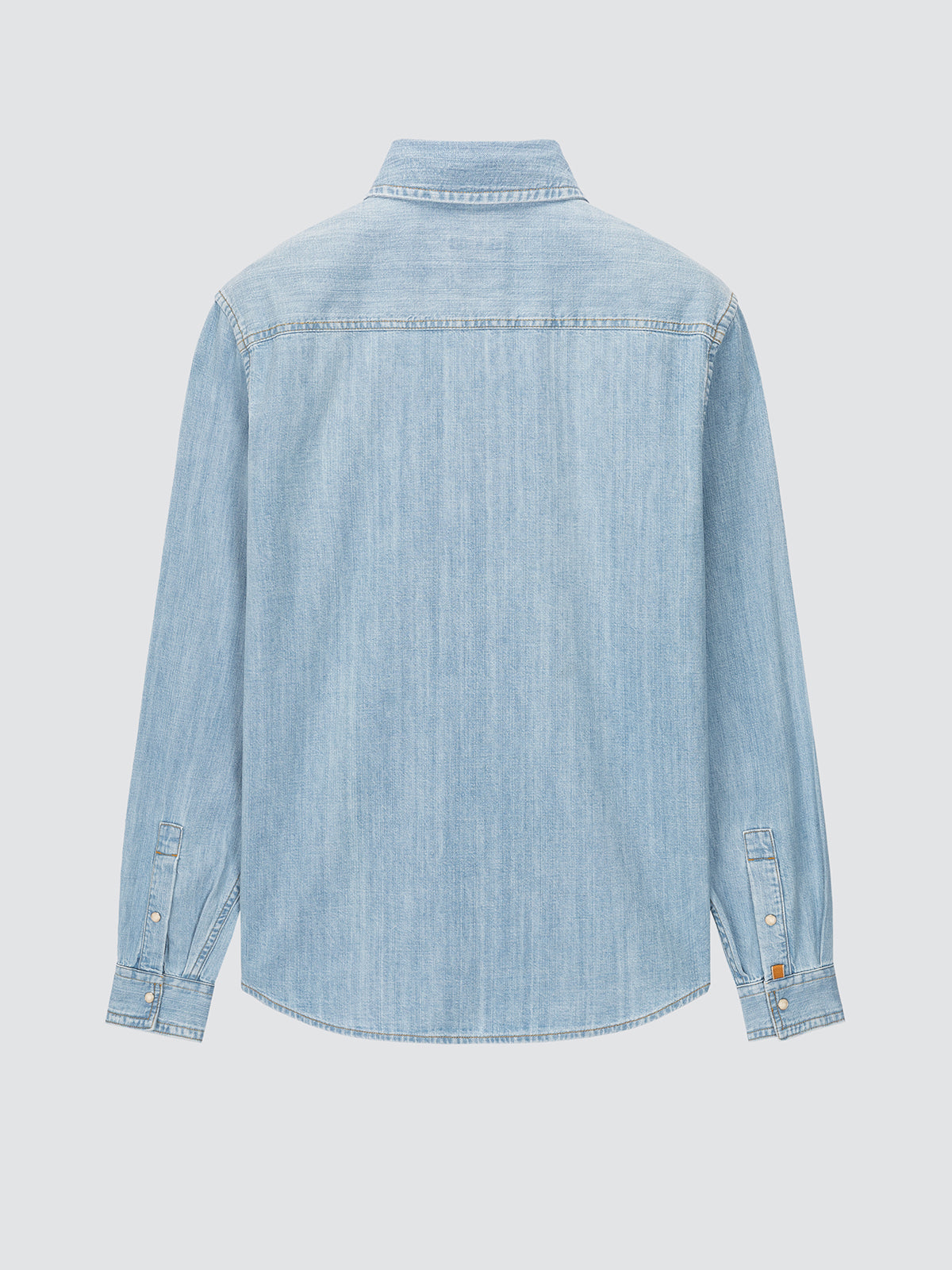 Light blue denim shirt on a light gray background