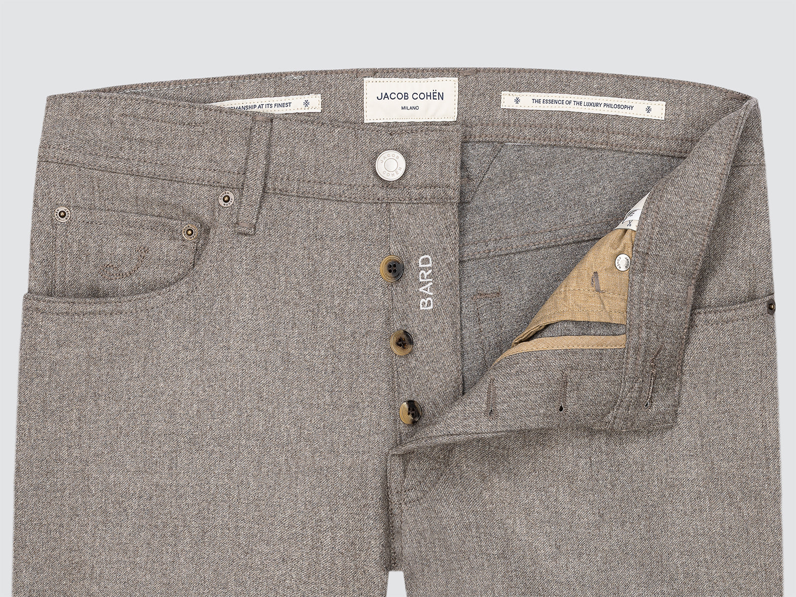 Gray pants with button details and Jacob Cohen branding on a light gray background
