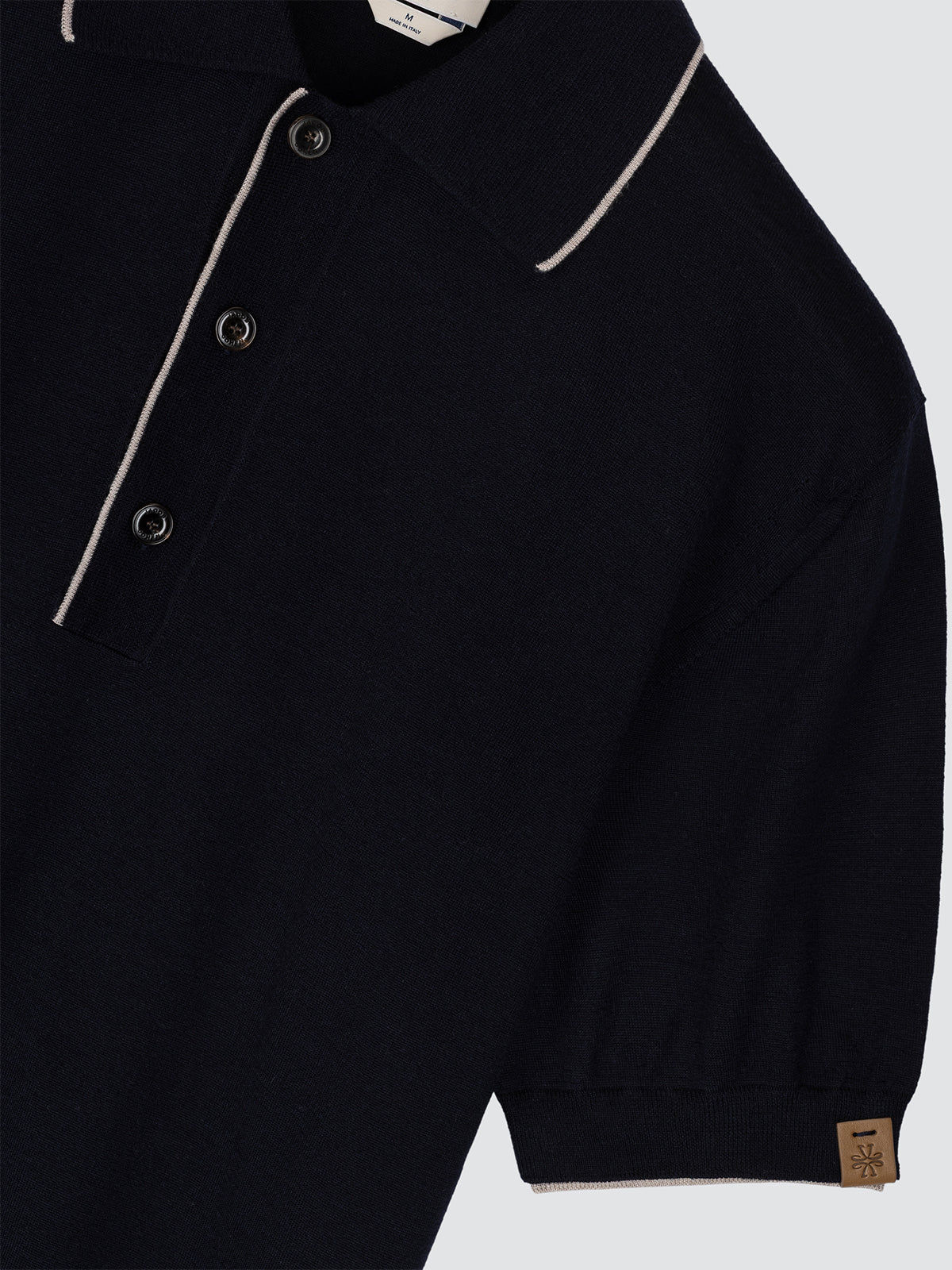 Navy blue polo with beige trim on a light gray background Jacob Cohen