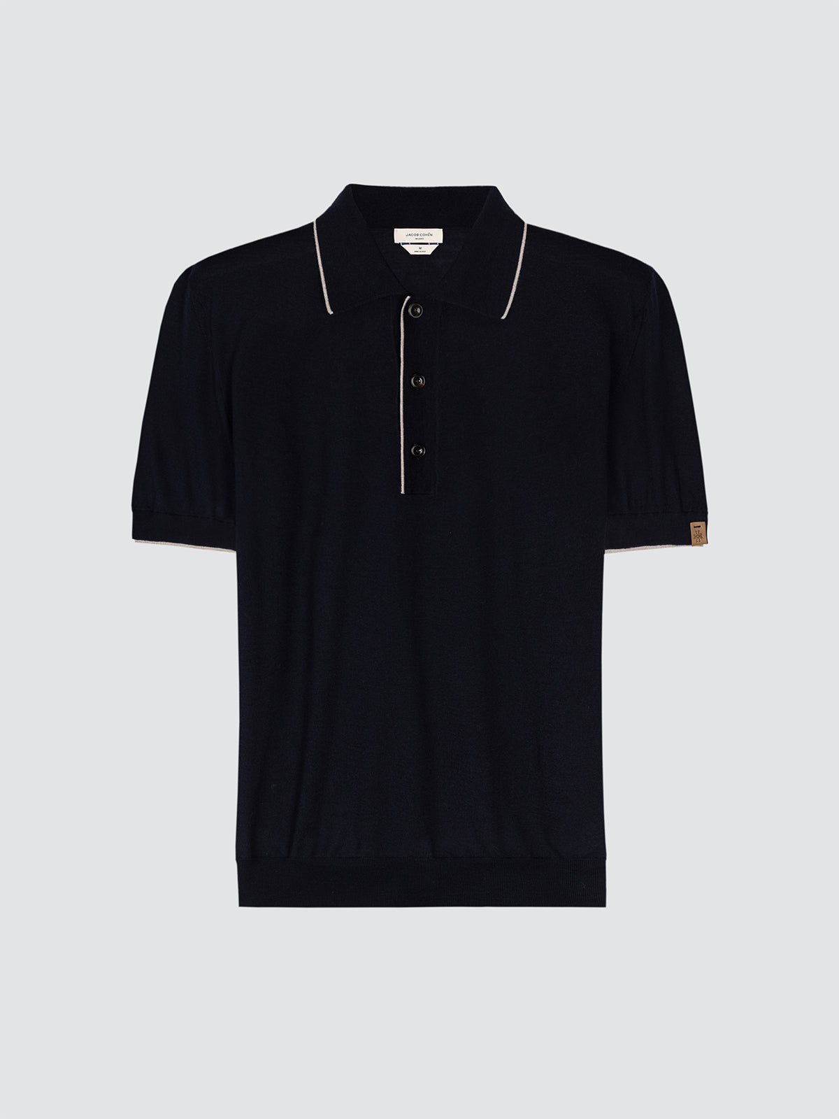 Navy polo shirt knitted with beige trim on a light gray background